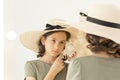 Beautiful young caucasian girl in a straw hat is posing with a white seashell. The girl listens to the sound of the sea.A portrait Royalty Free Stock Photo