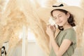 Beautiful young caucasian girl in a straw hat with a white seashell. The girl closed her eyes and listens to the sound of the sea Royalty Free Stock Photo