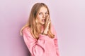 Beautiful young caucasian girl wearing casual clothes hand on mouth telling secret rumor, whispering malicious talk conversation Royalty Free Stock Photo