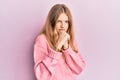 Beautiful young caucasian girl wearing casual clothes ready to fight with fist defense gesture, angry and upset face, afraid of Royalty Free Stock Photo