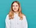 Beautiful young caucasian girl wearing casual sweatshirt smiling looking to the side and staring away thinking Royalty Free Stock Photo