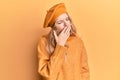 Beautiful young caucasian girl wearing french look with beret bored yawning tired covering mouth with hand Royalty Free Stock Photo