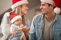 Beautiful young mom holding in arms her baby,  smiling, looking at her husband Royalty Free Stock Photo