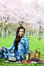 Beautiful Young Caucasian Woman in Blue Leather Jacket Having Picnic in Park Royalty Free Stock Photo