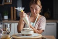 Beautiful young caucasian woman decorating cake with professional tools