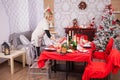 Beautiful young caucasian woman decorating the table for christmas dinner with her family Royalty Free Stock Photo