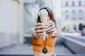 Beautiful young caucasian woman eating mint ice cream at the city street on a sunny day. Happy face smiling. Urban and summer Royalty Free Stock Photo