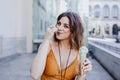 Beautiful young caucasian woman eating mint ice cream at the city street on a sunny day. Happy face smiling. Urban and summer Royalty Free Stock Photo