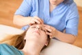 Beautiful young caucasian woman having face massage in spa salon. Relaxed woman having facial massage at the spa.