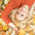 Woman lying down on yellow leaves Royalty Free Stock Photo