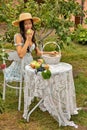 Beautiful young caucasian woman sitting in an orchard