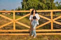 Beautiful young caucasian woman standing at the ranch gate Royalty Free Stock Photo