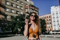 Beautiful young caucasian woman walking at the city street on a sunny day. Sending an audio with mobile phone. Happy face smiling Royalty Free Stock Photo