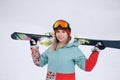 A beautiful young chew in an extreme sports suit, a hat and a helmet with a mask on the winter slope is holding alpine Royalty Free Stock Photo