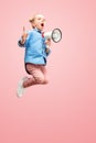 Beautiful young child teen girl jumping with megaphone isolated over pink background Royalty Free Stock Photo