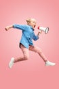 Beautiful young child teen girl jumping with megaphone isolated over pink background Royalty Free Stock Photo