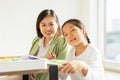 beautiful young children happy, smile, look at camera, fun painting color in education classroom, select focus at child. asian Royalty Free Stock Photo