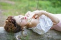 Beautiful young chubby girl posing in medieval retro corset and white vintage lingerie in the forest Royalty Free Stock Photo