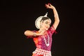 Beautiful young Classical Odissi or orissi dancer performing on stage at Konark Temple, Odisha, India.