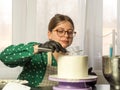 Confectioner girl makes a cake