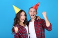 Young couple in birthday paper caps