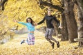 Beautiful young couple celebrate and jumping after successful training in the park