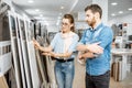 Couple choosing ceramic tiles in the shop Royalty Free Stock Photo