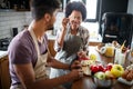 Beautiful young couple cooking healthy food together at home. Having fun in the kitchen. Royalty Free Stock Photo