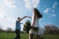 Beautiful young couple dancing and having fun on blue sky background Royalty Free Stock Photo