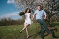 Beautiful young couple dancing and having fun on blue sky background Royalty Free Stock Photo