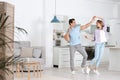 Beautiful young couple dancing in kitchen