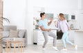 Beautiful young couple dancing in kitchen Royalty Free Stock Photo