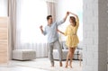 Beautiful couple dancing in living at home