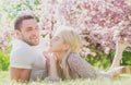 Beautiful young couple enjoying flowering garden. Affectionate tenderness couple. Happy family. Royalty Free Stock Photo