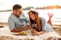 Beautiful young couple enjoying picnic on a beach Royalty Free Stock Photo