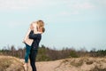 Beautiful young couple enjoying spring beach vacation, playful on sunny blue sky outdoors.having fun and being active Royalty Free Stock Photo