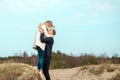 Beautiful young couple enjoying spring beach vacation, playful on sunny blue sky outdoors.having fun and being active Royalty Free Stock Photo