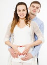 Beautiful young couple expecting baby, make hearth hand Royalty Free Stock Photo