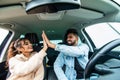 Beautiful young indian couple is giving high five and smiling while travelling by car Royalty Free Stock Photo