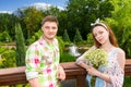 Beautiful young couple having a date on a bridge in the park Royalty Free Stock Photo