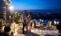 Beautiful young couple having date at rooftop restaurant. Royalty Free Stock Photo