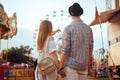 Beautiful, young couple having fun at an amusement park. Couple Dating Relaxation Love Theme Park Concept. Couple posing together Royalty Free Stock Photo