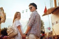 Beautiful, young couple having fun at an amusement park. Couple Dating Relaxation Love Theme Park Concept. Couple posing together Royalty Free Stock Photo