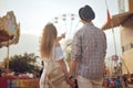 Beautiful, young couple having fun at an amusement park. Couple Dating Relaxation Love Theme Park Concept. Couple posing together Royalty Free Stock Photo