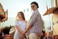 Beautiful, young couple having fun at an amusement park. Couple Dating Relaxation Love Theme Park Concept. Couple posing together Royalty Free Stock Photo