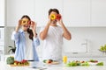 Beautiful young couple having fun while cooking healthy food in kitchen at home Royalty Free Stock Photo