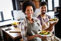 Beautiful young couple having fun and laughing while cooking in kitchen Royalty Free Stock Photo