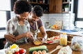 Beautiful young couple having fun and laughing while cooking in kitchen Royalty Free Stock Photo
