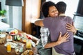 Beautiful young couple having fun and laughing while cooking in kitchen Royalty Free Stock Photo