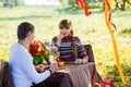 Beautiful Young Couple Having Picnic in autumn Park. Happy Family Outdoor. Smiling Man and Woman relaxing in Park. Relationships. Royalty Free Stock Photo